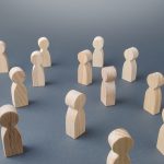 Wooden figures of people standing apart from each other