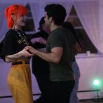 A couple dances salsa at a Rueda de la Vida Dance Society social in Vancouver